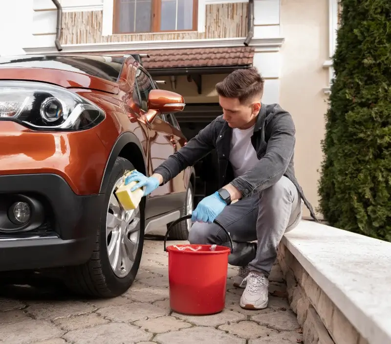 Lavage auto à domicile Ambrières-les-Vallées : professionnel intervenant sur un véhicule